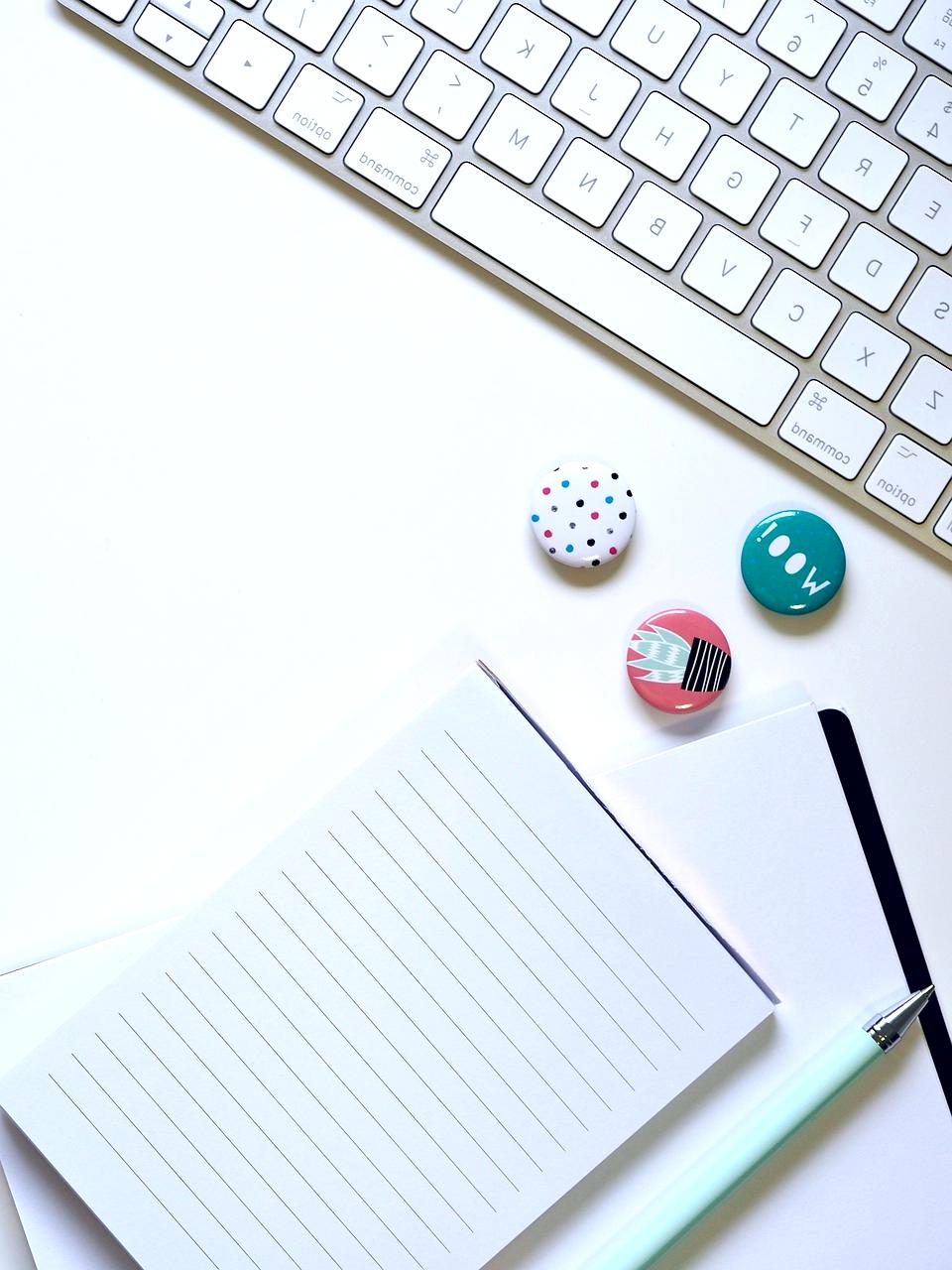 Modern creative workspace with laptop, notebooks, and design elements showcasing blog content creation